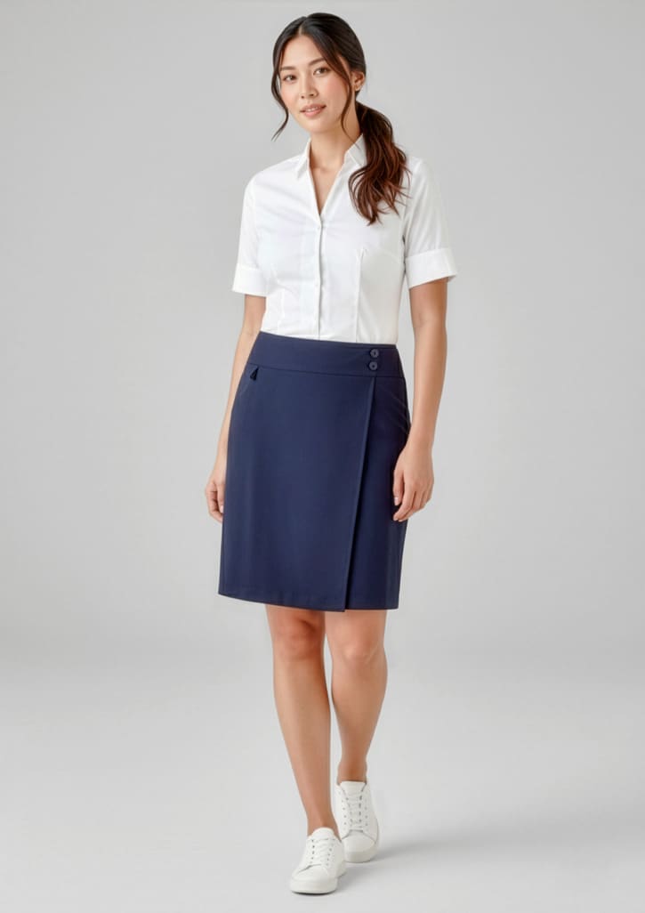 A woman wearing a navy skort and a white shirt, standing in a neutral background. The skort features a logo. Womens Comfort Waist Skort - Image 1