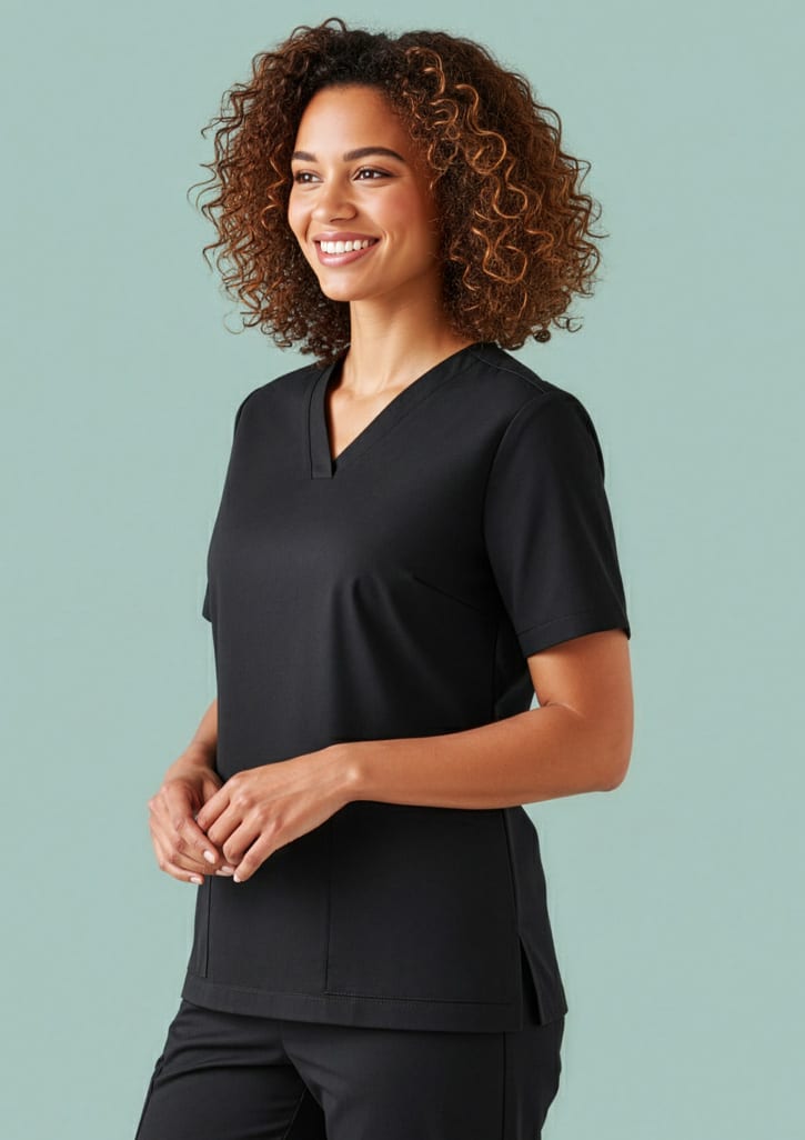 A black women's scrub top with a v-neck and short sleeves, featuring a logo on the fabric. Womens Tokyo Scrub Top - Image 1