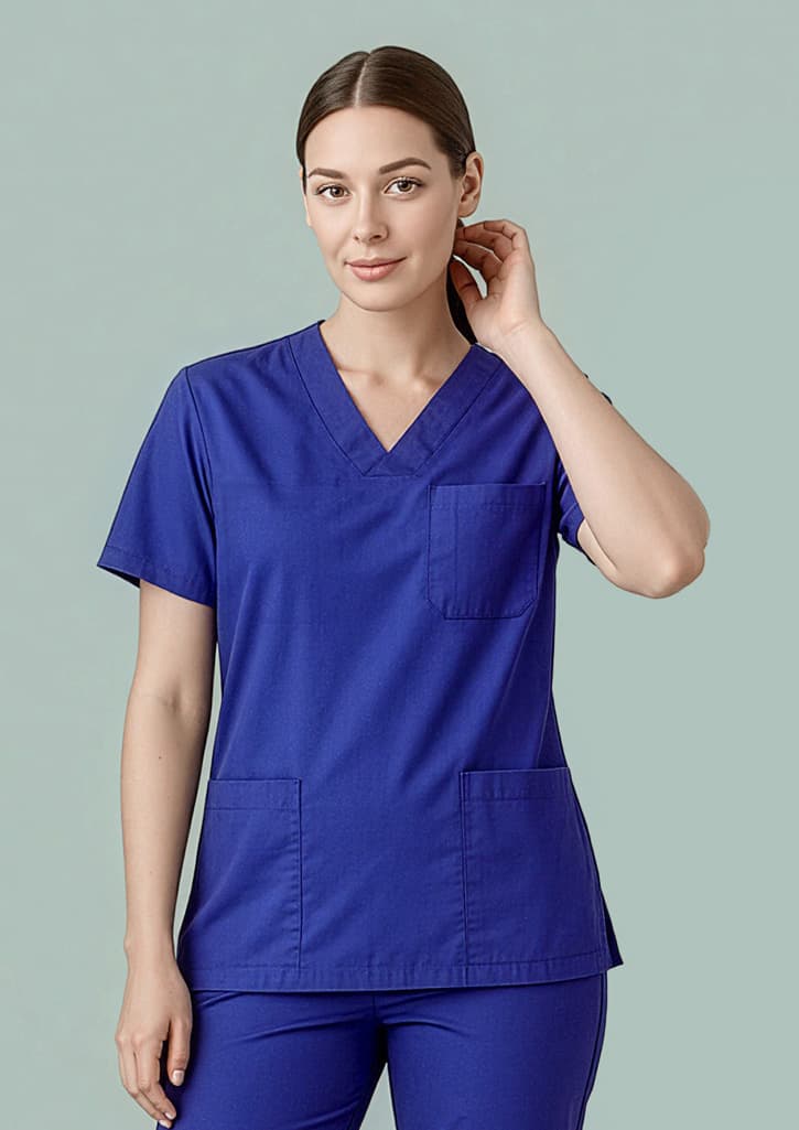 A reversible scrub top in royal blue featuring short sleeves and a front pocket, modelled by a person. Unisex Hartwell Reversible Scrub Top - Image 1
