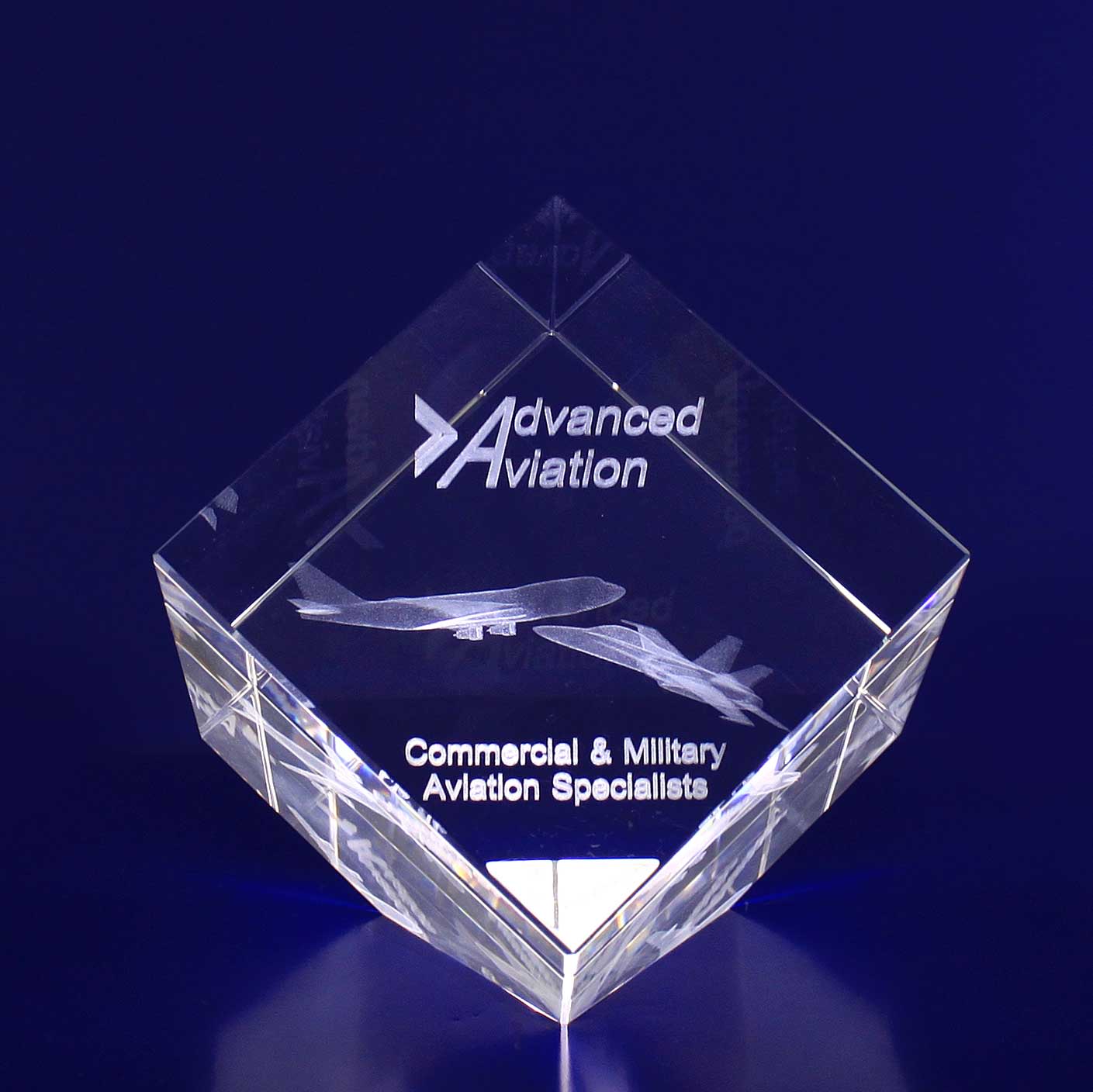 A 3D crystal diamond, 80mm in size, featuring etched aircraft designs and a logo on a blue backdrop. 3D Crystal Diamond (80mm) - Image 1