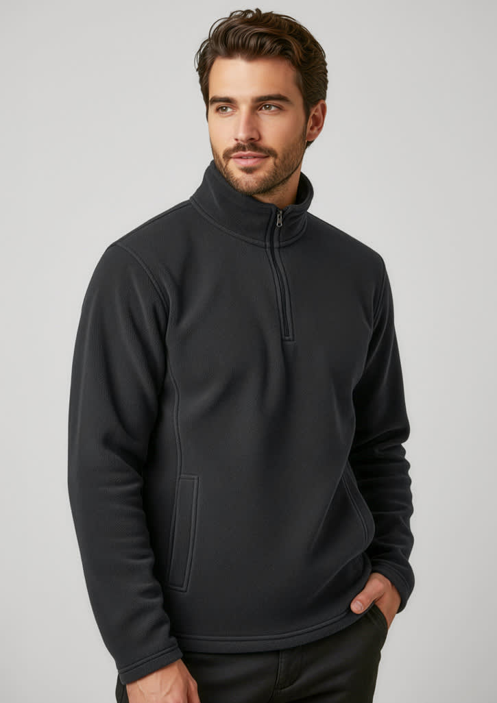 A black polar fleece jacket featuring a quarter-zip and a side pocket, worn by a man. Includes a logo. Mens Trinity Fleece - Image 1