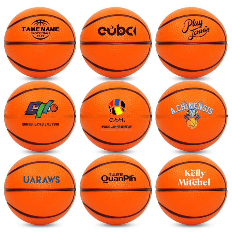 Nine orange basketball-shaped stress relievers arranged in a grid, each featuring a different logo. Basketball Shaped Stress Reliever - Image 1