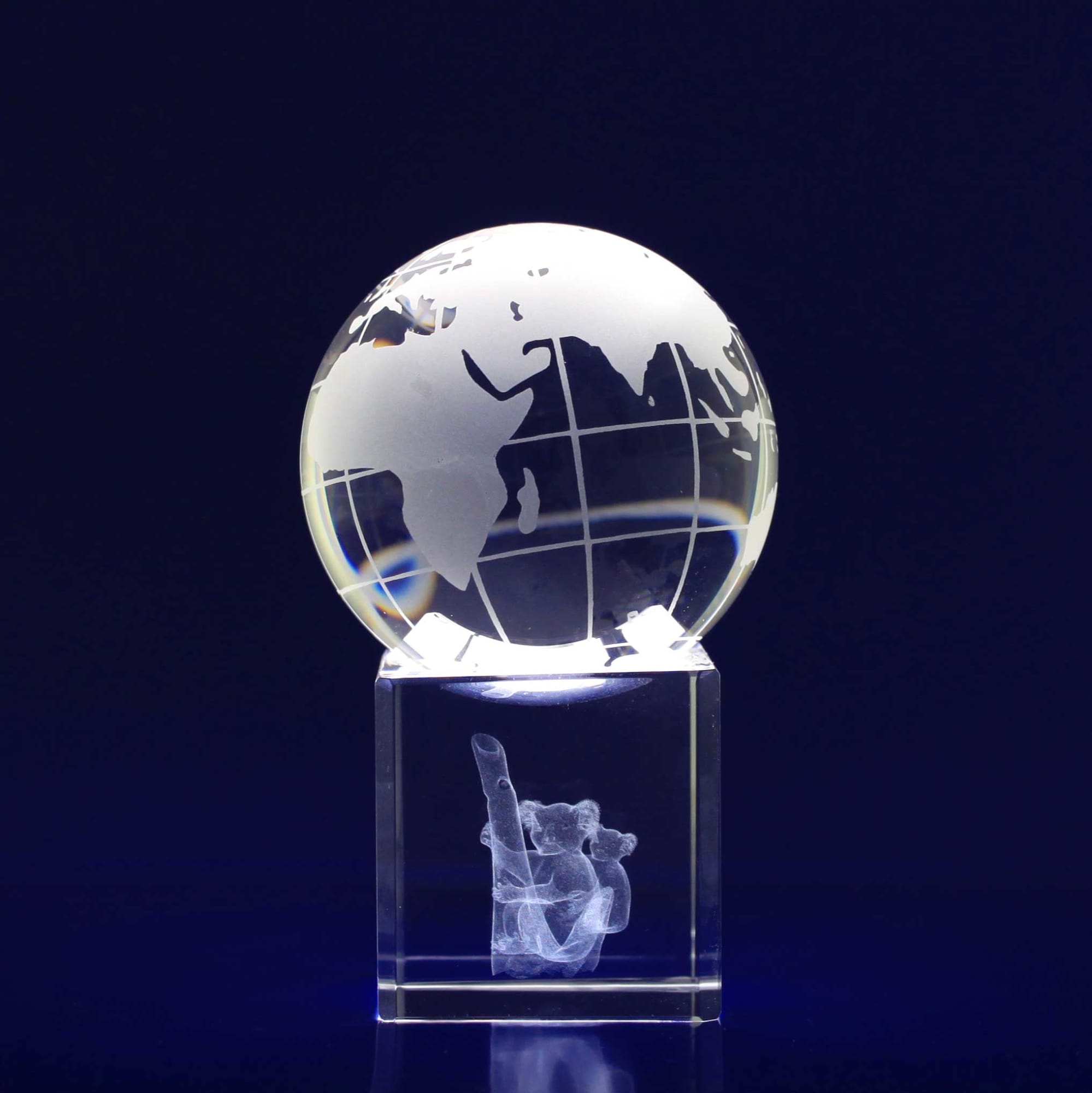 A 60mm crystal spinning globe featuring a clear design with geographical outlines, set on a transparent base. 3D Crystal Spinning World Globe (60mm diametre) - Image 1