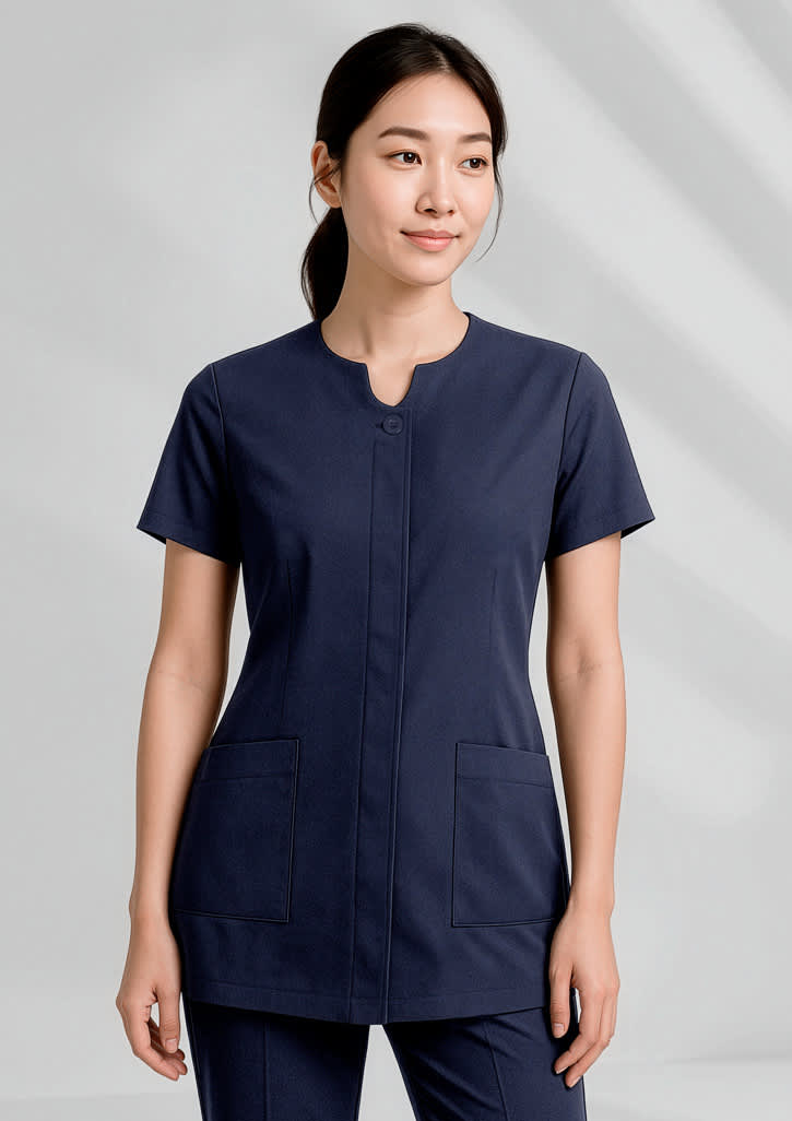 A navy women's tunic with a round neckline and two front pockets, featuring a logo on the chest. Womens Eden Tunic - Image 1
