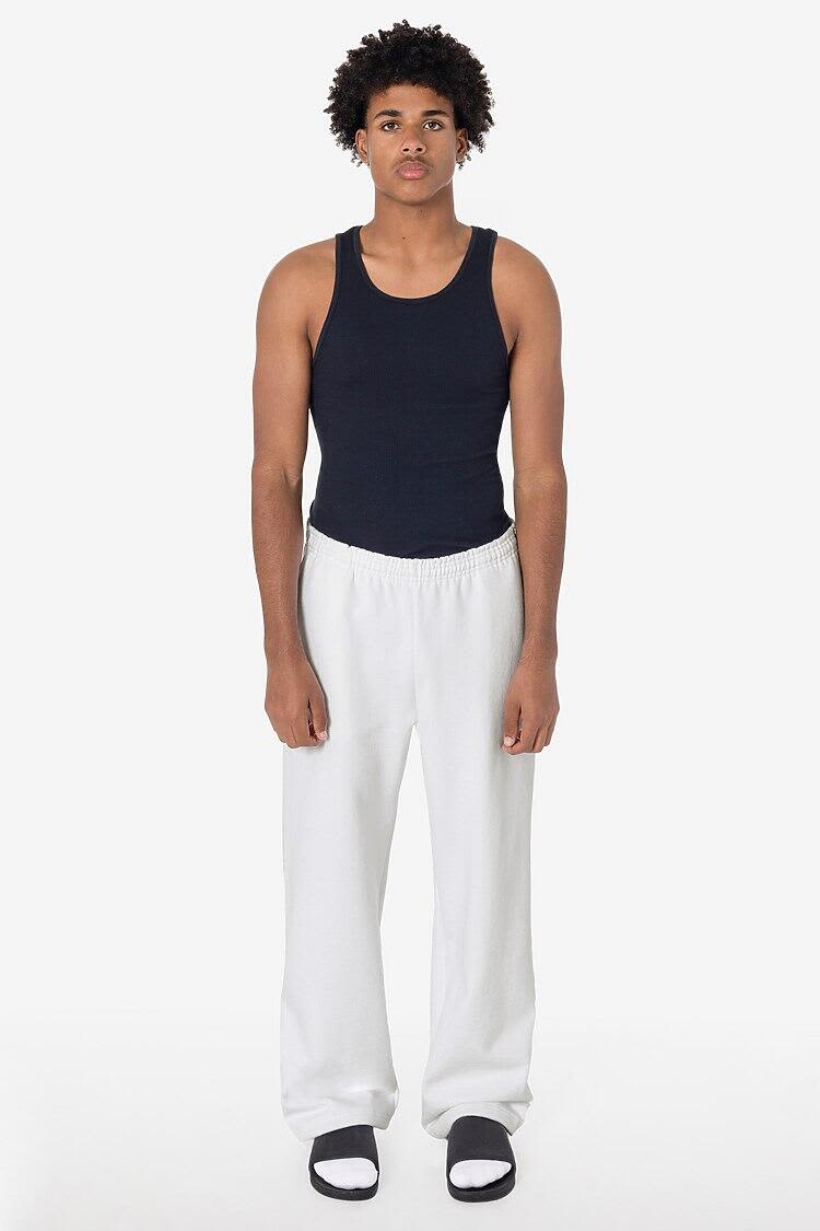 A model wearing straight leg heavy fleece pants in white, paired with a navy tank top and black slides. Straight Leg Heavy Fleece Pant - Image 1