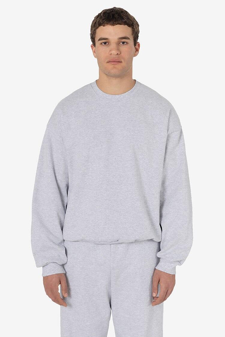 A grey heavy fleece pullover with long sleeves, displayed on a model. The product has a logo. Heavy Fleece Pullover - Image 1