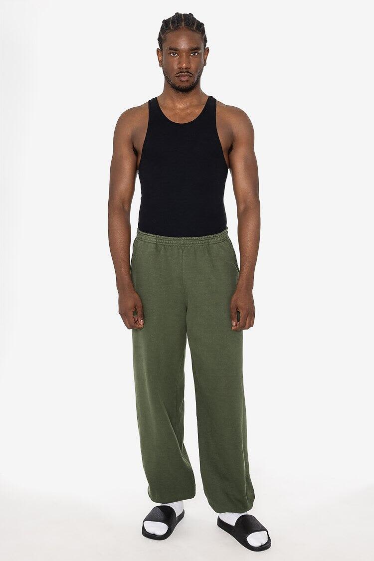 A man wearing an olive green heavy fleece sweatpant and a black tank top, standing against a white background. Garment Dye Heavy Fleece Sweatpant - Image 1