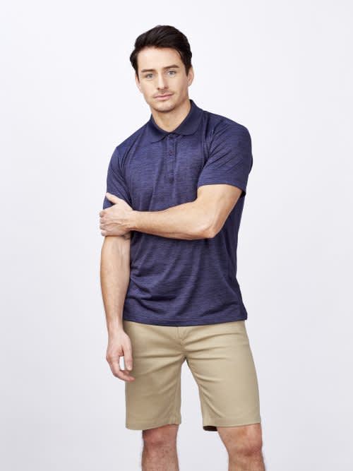 A navy blue men's polo shirt displayed on a model, featuring a logo and styled with beige shorts. Bailey - Mens Polo - Image 1