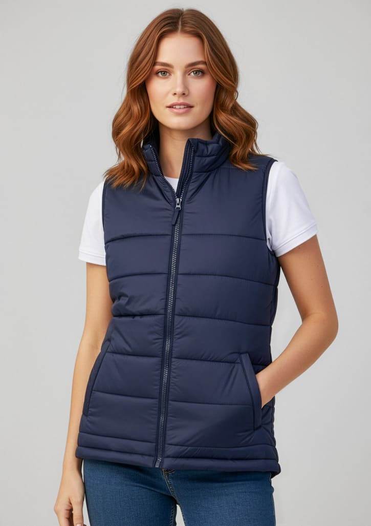 A navy woman's vest with a zip, featuring a quilted design and pockets, worn over a white t-shirt. Womens Alpine Vest - Image 1