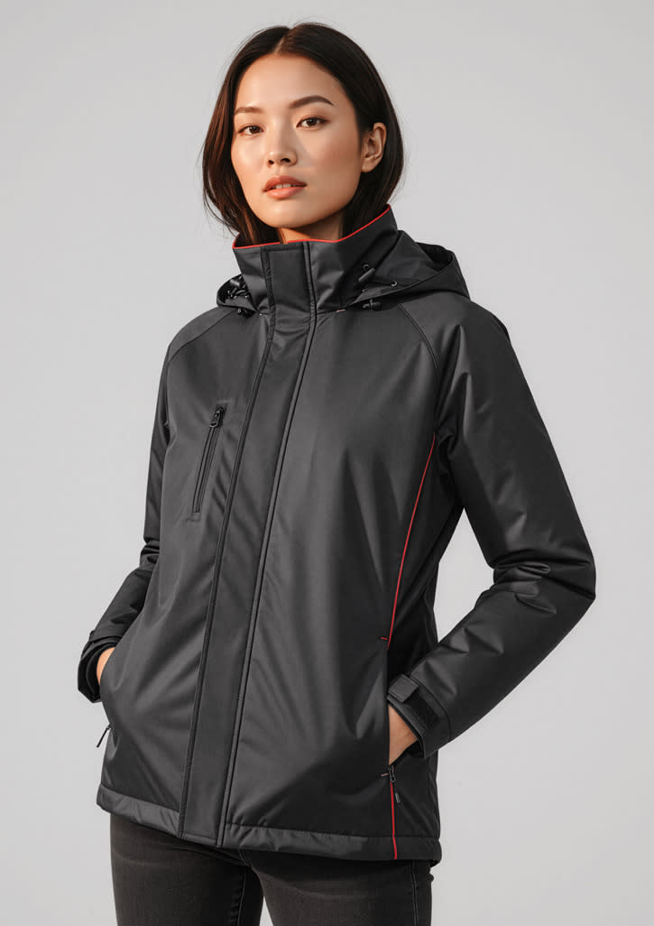 A black unisex jacket with a hood, featuring red detailing and a zippered front, displayed on a model. Unisex Core Jacket - Image 1