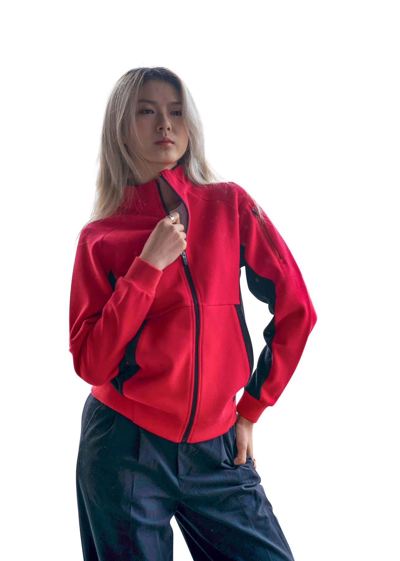 A woman wearing a bright red jacket with black accents, featuring a zippered front and a logo. Womens' Icon Jacket - 420 gsm - Image 1