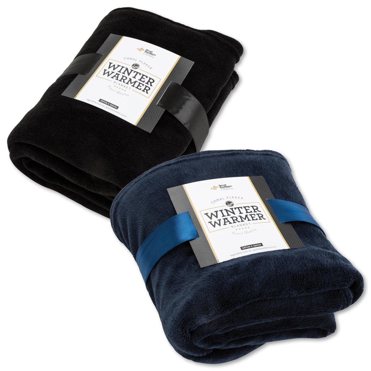 A folded coral fleece blanket in black and navy blue, each with a ribbon and a branding label. Coral Fleece Blanket - Image 1