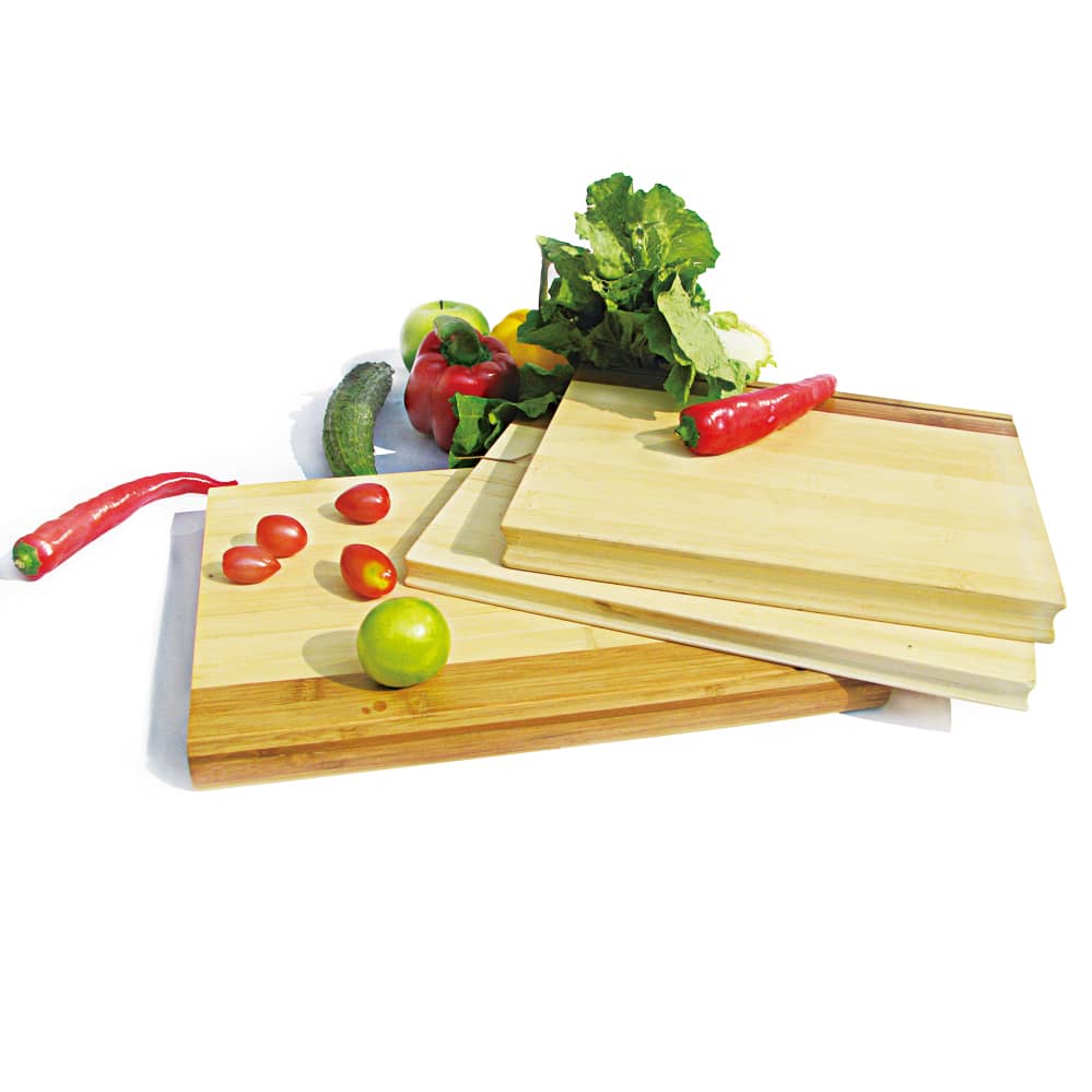 A set of bamboo chopping boards in various sizes, featuring fresh vegetables like tomatoes, chilli, cucumber, and lettuce. Stingray chopping board - Image 1