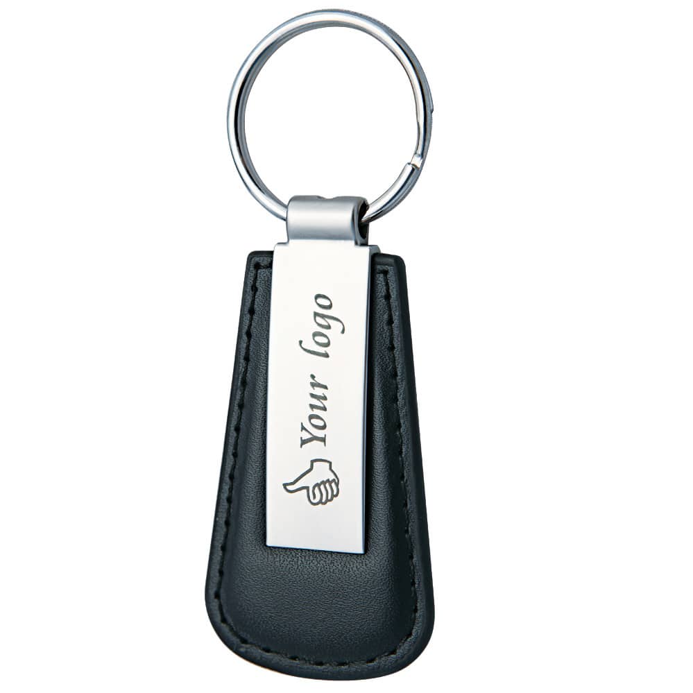 A keyring featuring a black leather holder and a metallic tag, with a logo on the tag. Calvin keyring - Image 1