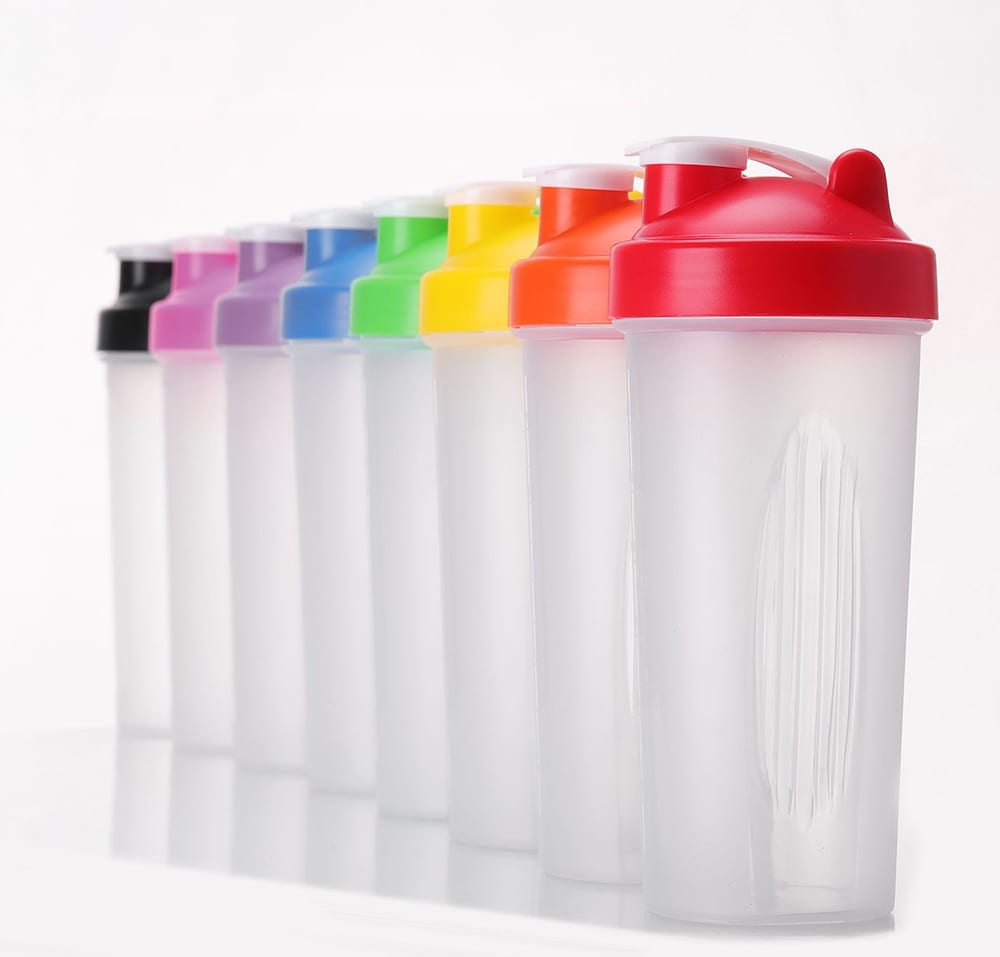 A drink bottle in various colours, featuring a flip-top lid and a visible mixing ball inside. It has a logo on the side. Jackie pp plastic shaker - Image 1