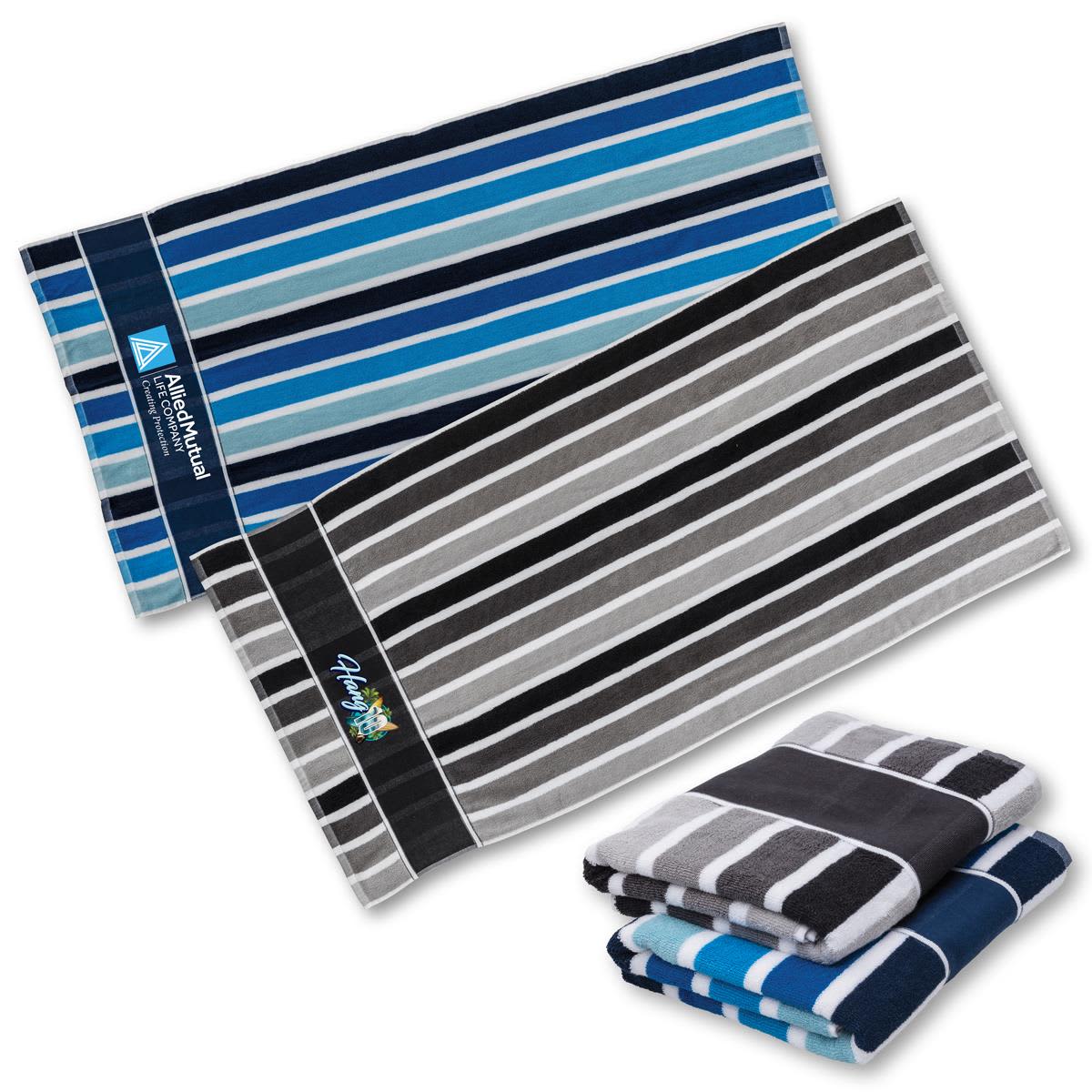 A set of striped towels in shades of blue, grey, and black, featuring a logo on one towel. Cabana Towel - Image 1