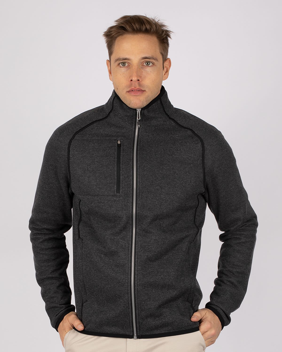 A men's full zip jacket in dark grey, featuring a sleek design and a zippered chest pocket. It has a logo. Men's Mainsail Full Zip Jacket - Image 1