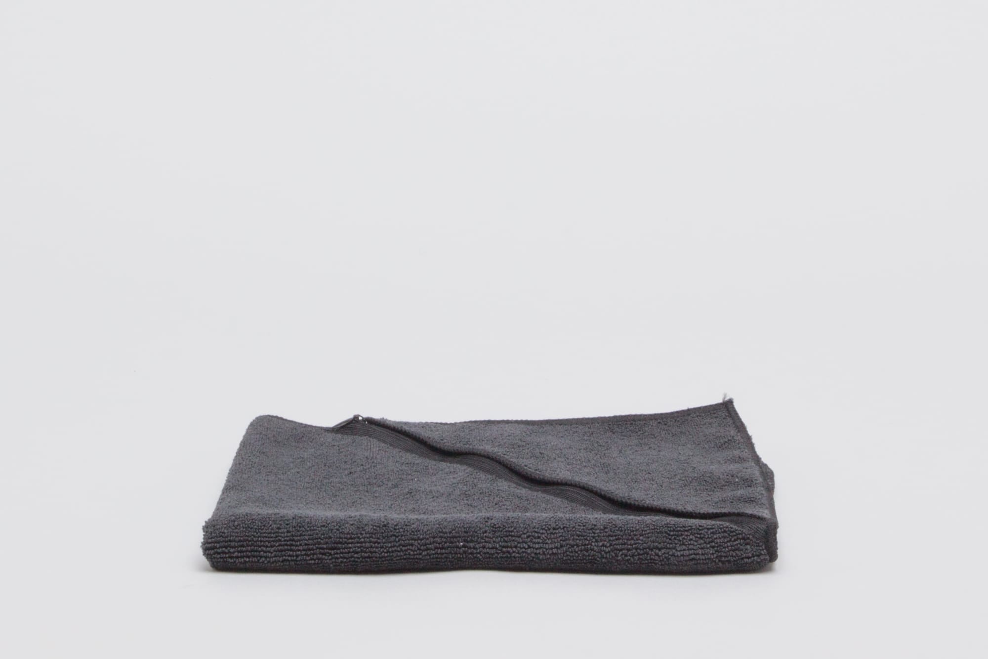 A folded black towel displayed on a plain background, featuring a soft texture. Sports 300 gsm Black - Image 1