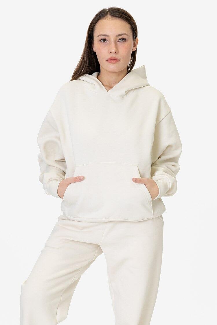 A model wearing a cream-coloured mineral wash fleece wide hoodie, featuring a hood and front pockets. Mineral Wash Fleece Wide Hoodie - Image 1