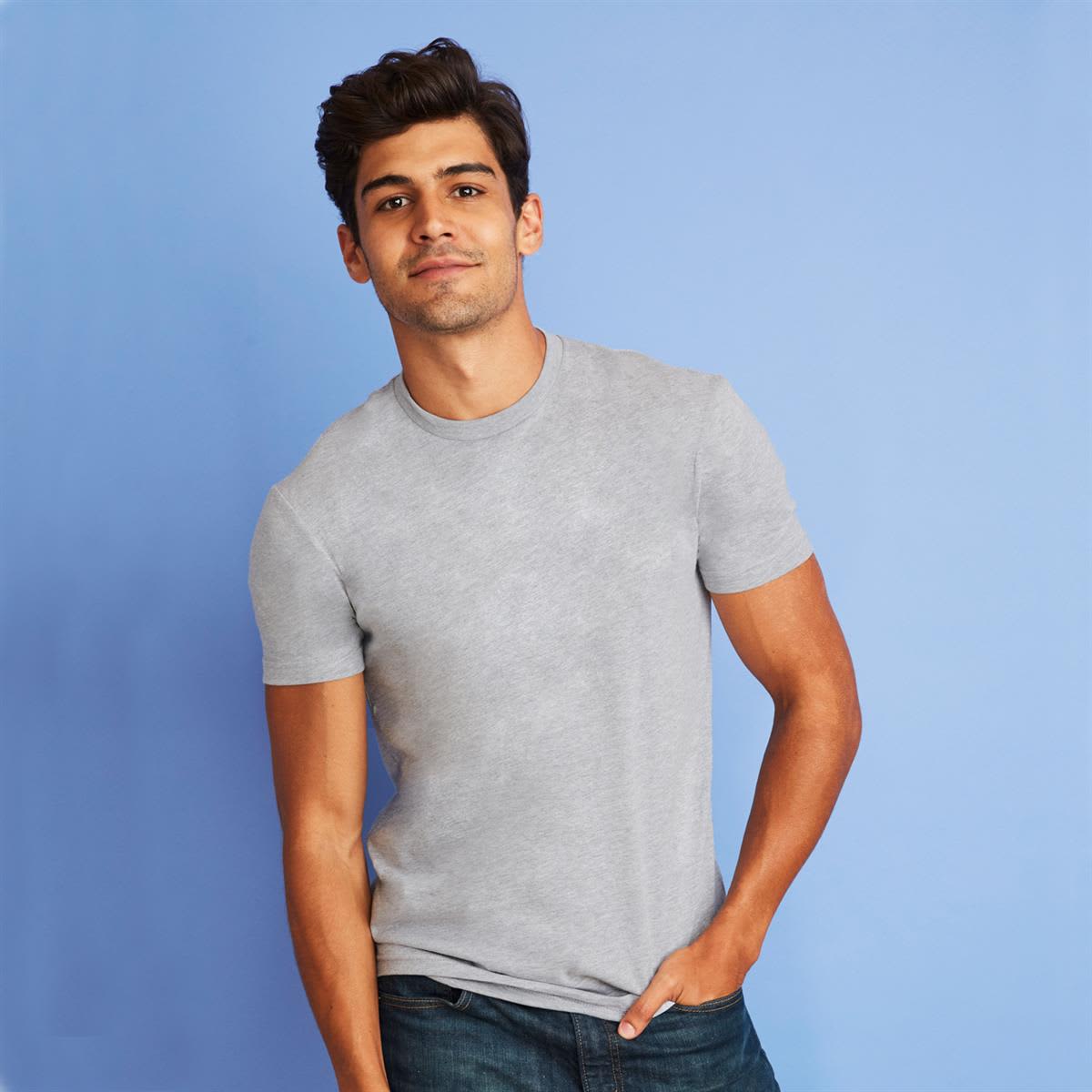 A grey men's cotton crew t-shirt displayed on a model against a light blue background. The shirt features a logo. Men's Cotton Crew - Image 1