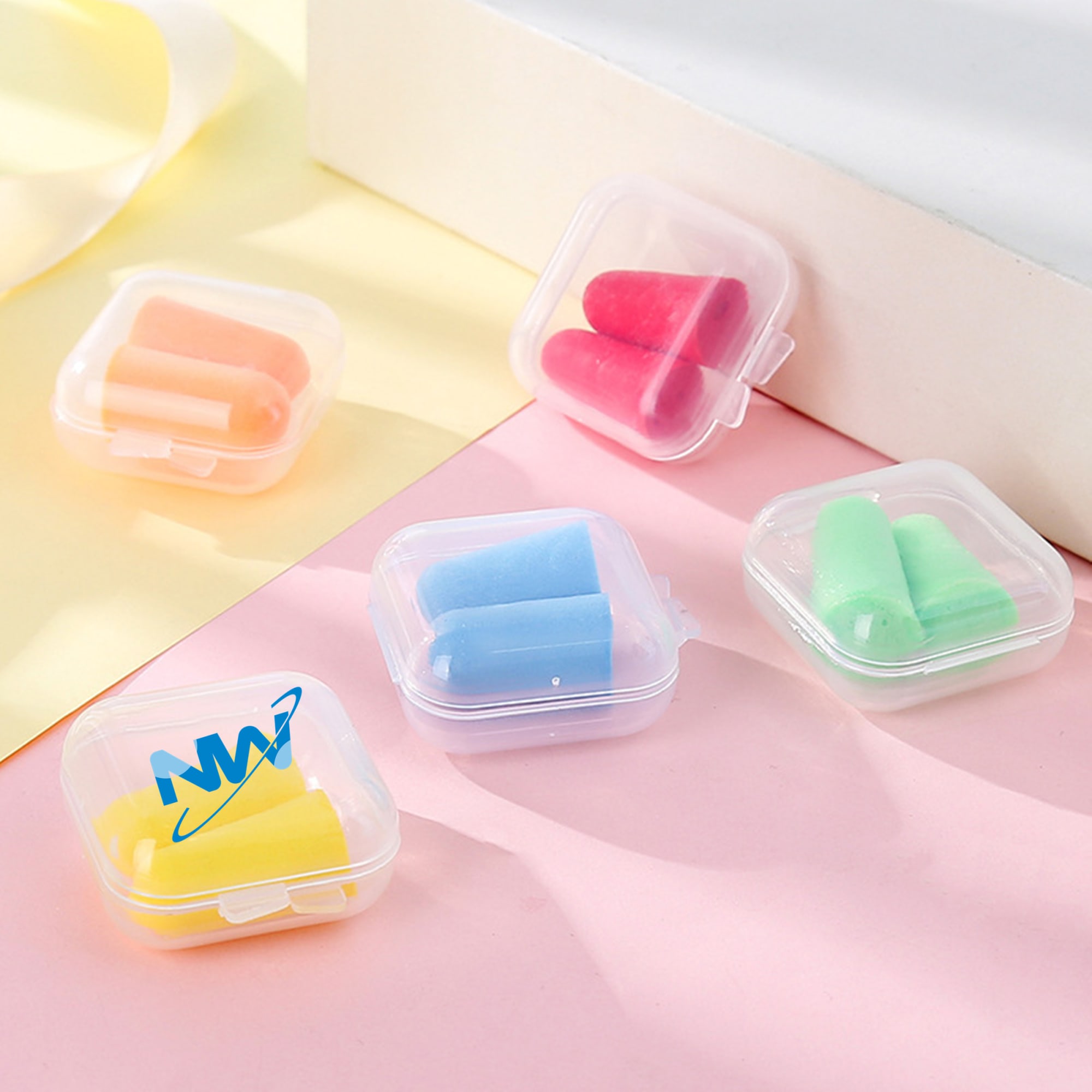 Earplugs in various colours, including pink, blue, orange, and green, housed in clear plastic cases. Each case has a logo. Earplugs in Case - Image 1