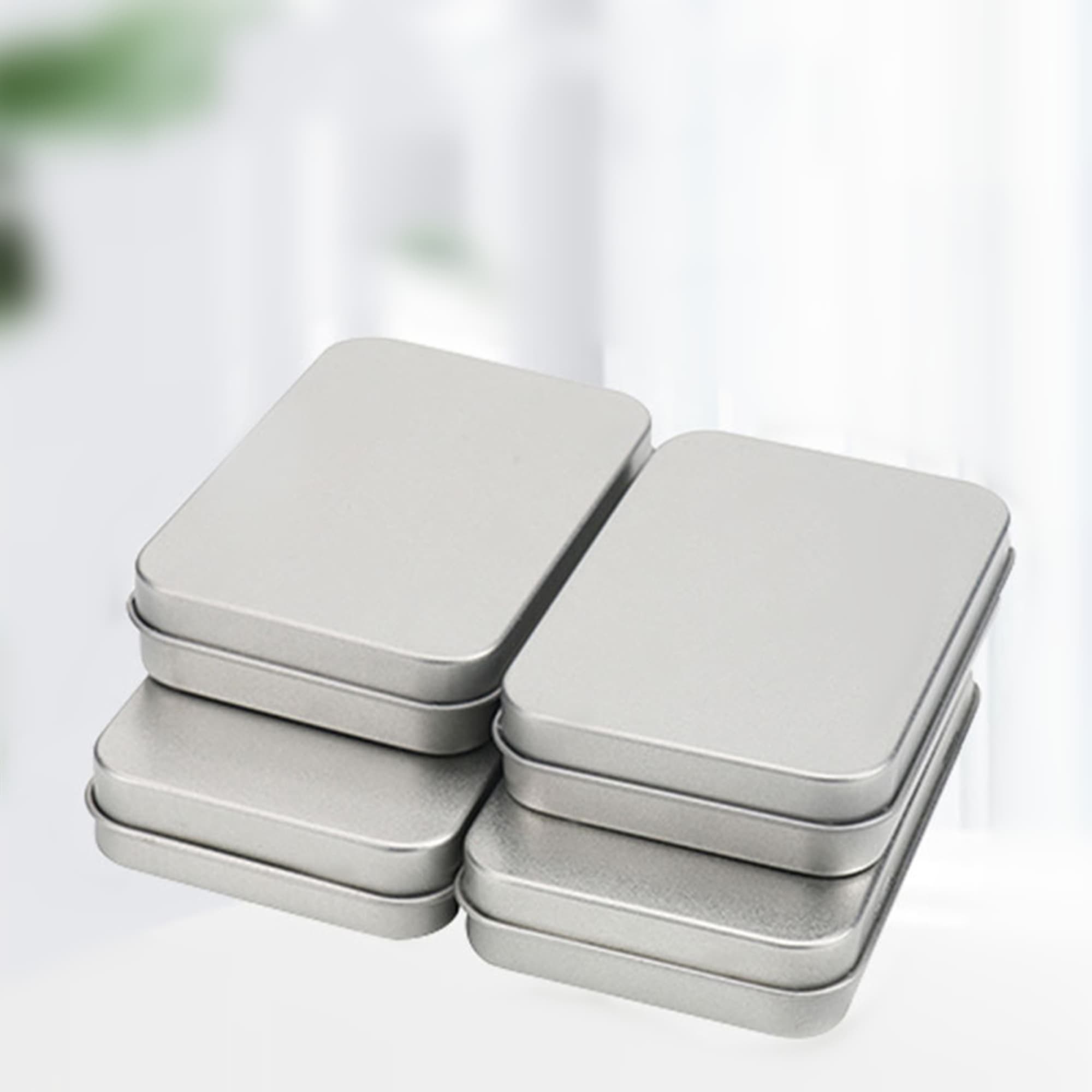 A set of silver tinplate boxes stacked together, featuring a smooth finish and rectangular shape. Tinplate Box - Image 1