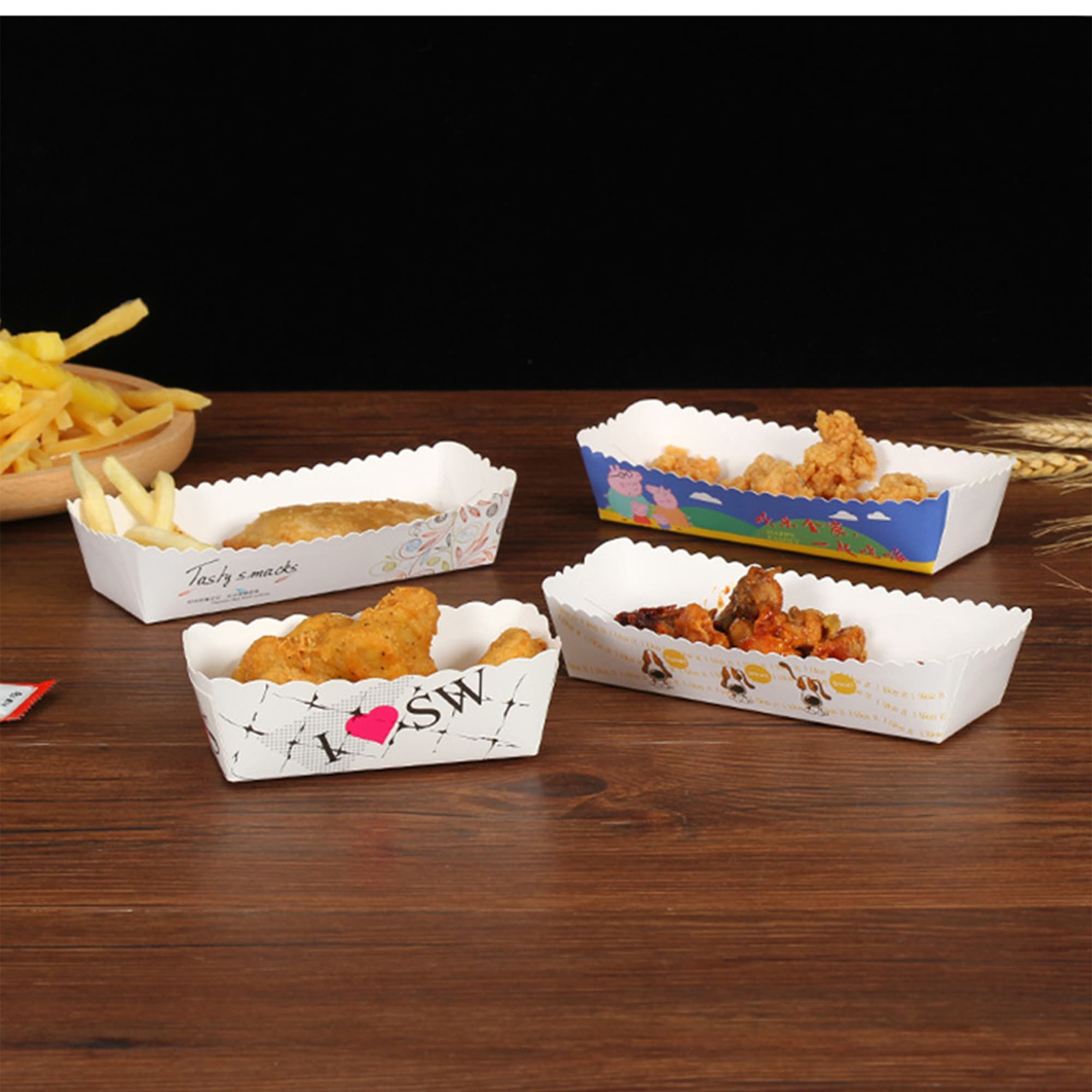 A collection of white food trays in various designs, containing fried chicken, chips, and other snacks. Food Tray - Image 1