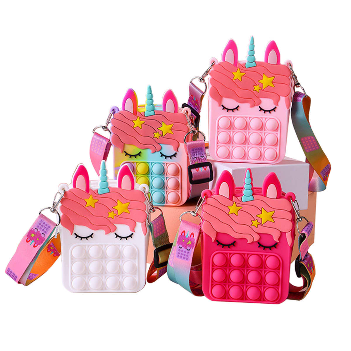 Four unicorn-shaped bags in pink, white, and multicolour with pop bubble features and adjustable straps. Pop Fidget Unicorn Bag - Image 1