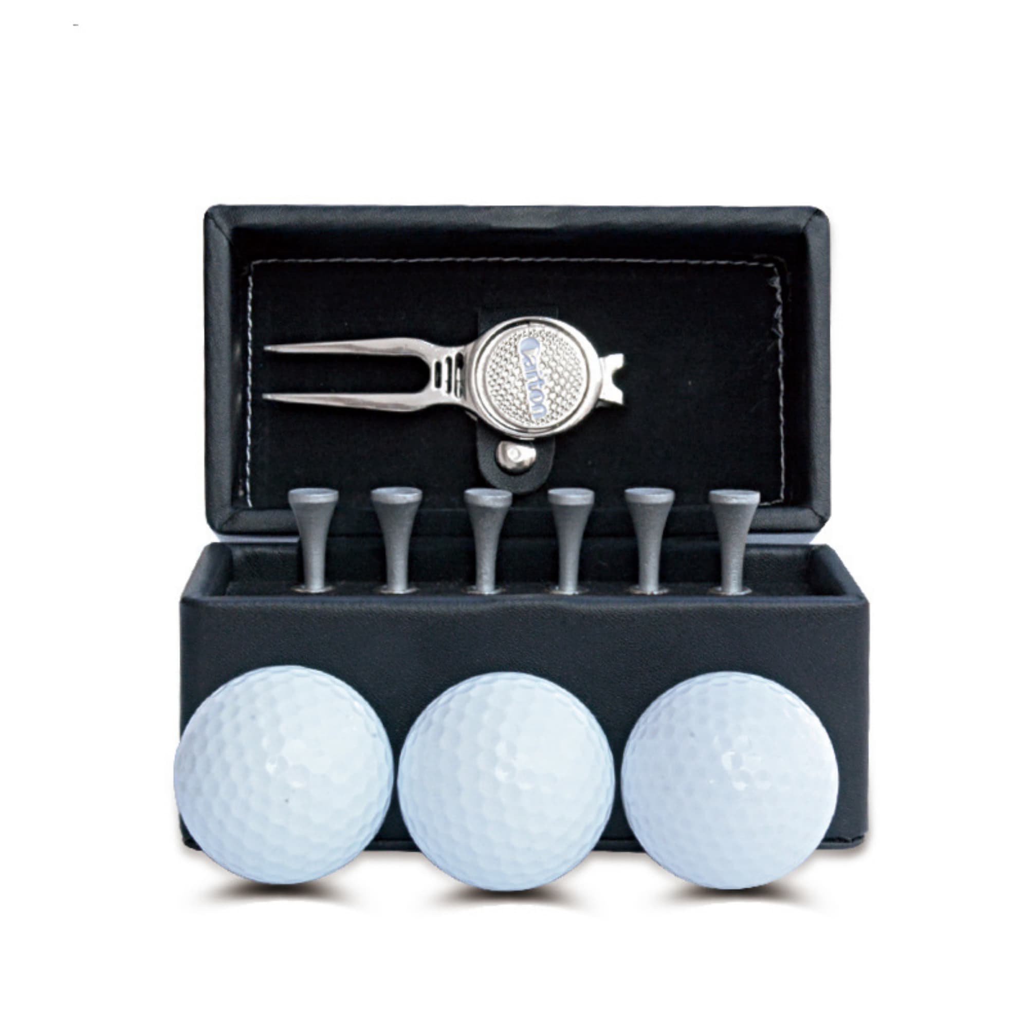 A black box containing three white golf balls, a silver pitchfork tool, and wooden tees. The box has a logo. Golf Set - Image 1