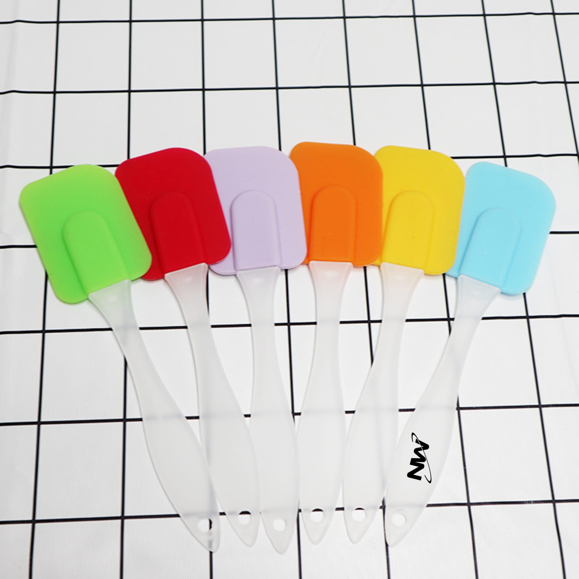 A set of six cream spatulas in vibrant colours: green, red, purple, orange, yellow, and blue, with clear handles. Cream Spatula - Image 1