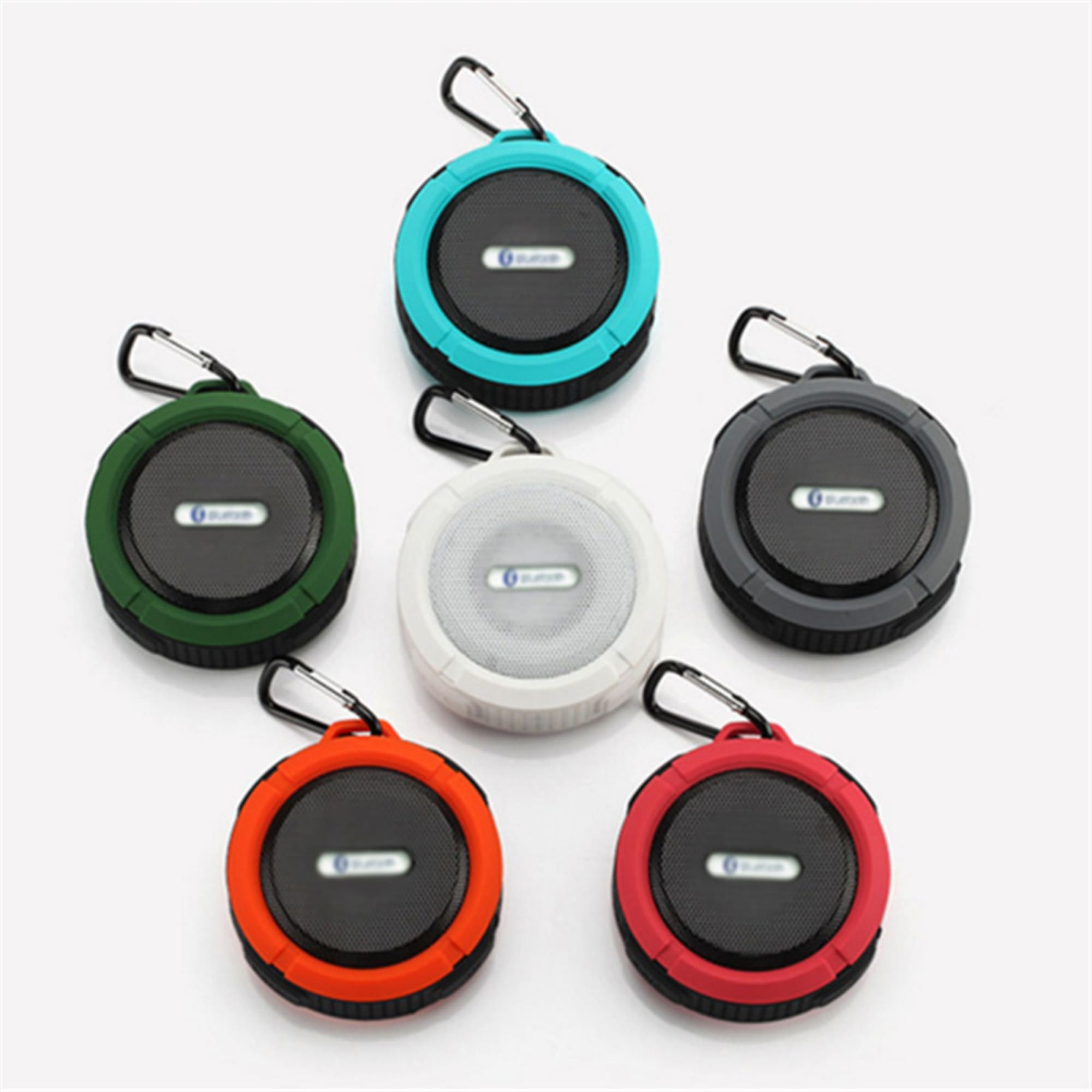 A range of waterproof Bluetooth speakers in black, white, red, green, blue, and orange, each with a carabiner clip. Waterproof Bluetooth Speaker - Image 1