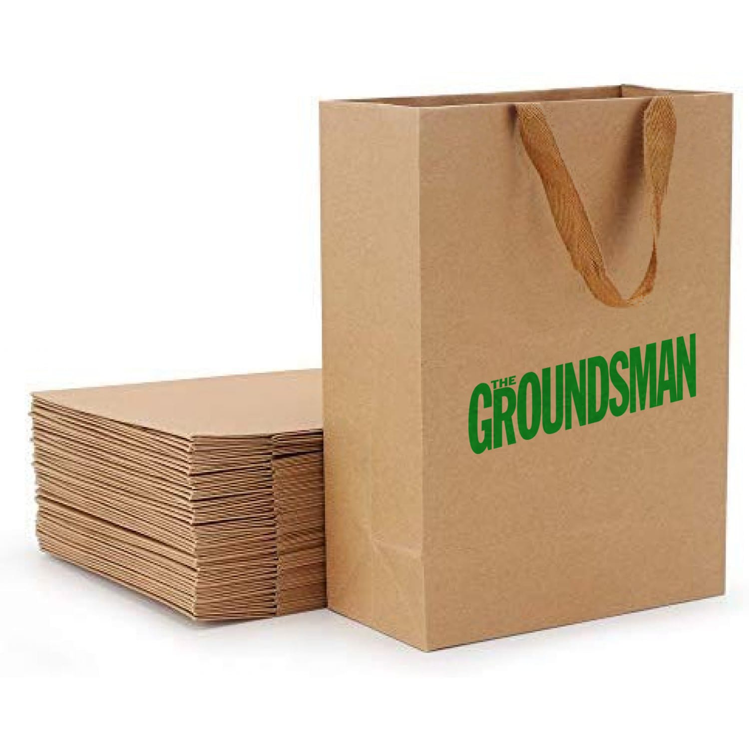 A brown recycled paper bag with a paper webbed handle, next to a stack of flat paper bags. 100% Recycled Paper Bag with Paper Webbed Handle - Image 1