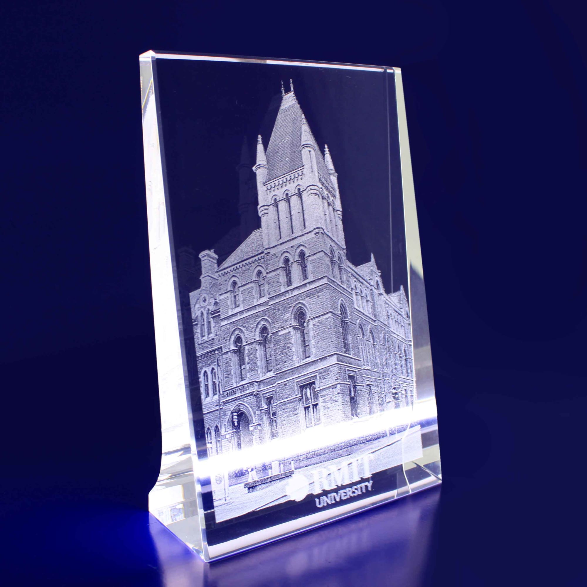 A clear 3D crystal photocrystal featuring a detailed building engraving with a logo at the base. 3D Crystal Vertical Photocrystal - Image 1