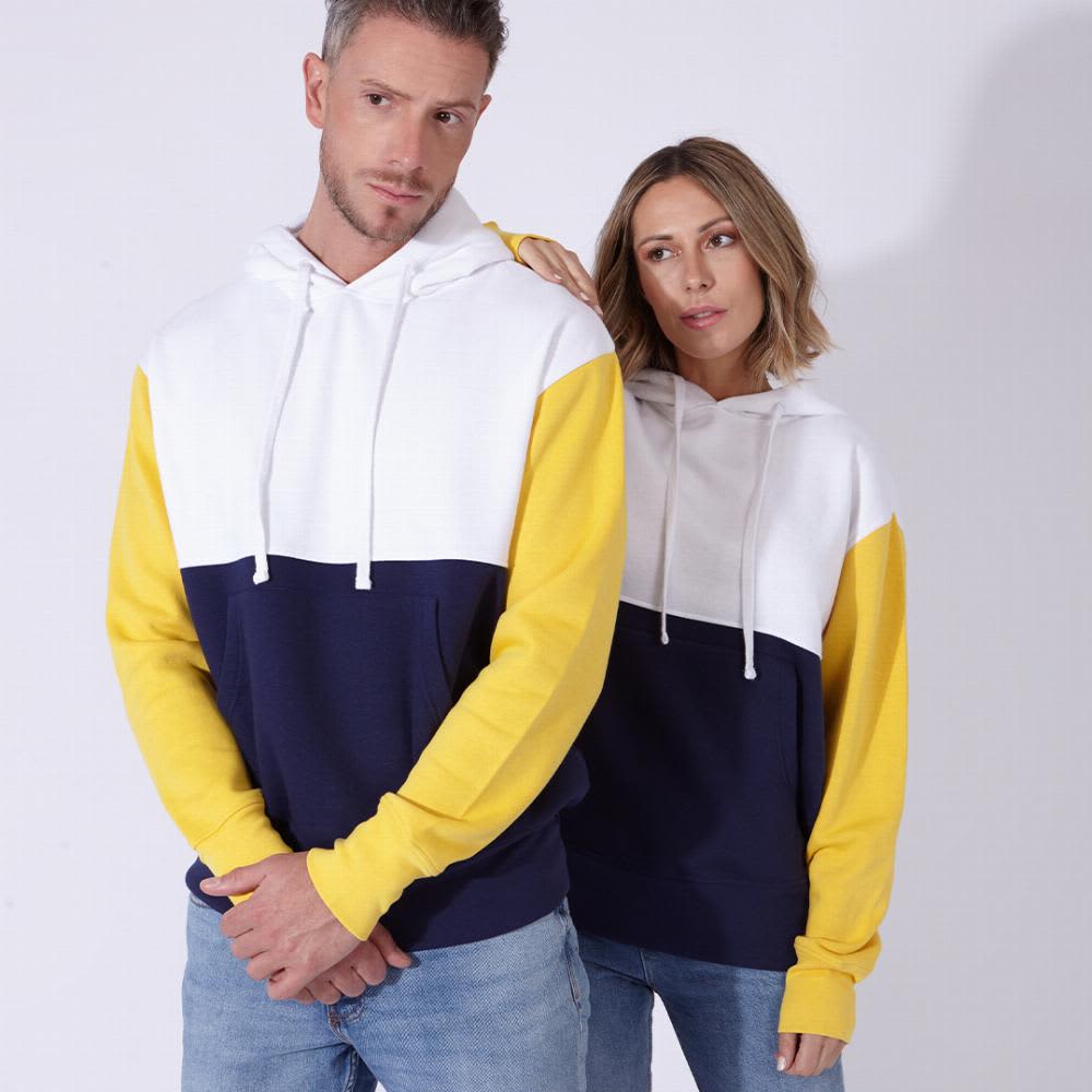 A hooded sweatshirt in blue, white, and yellow, worn by a man and a woman against a plain background. Skon - Image 1