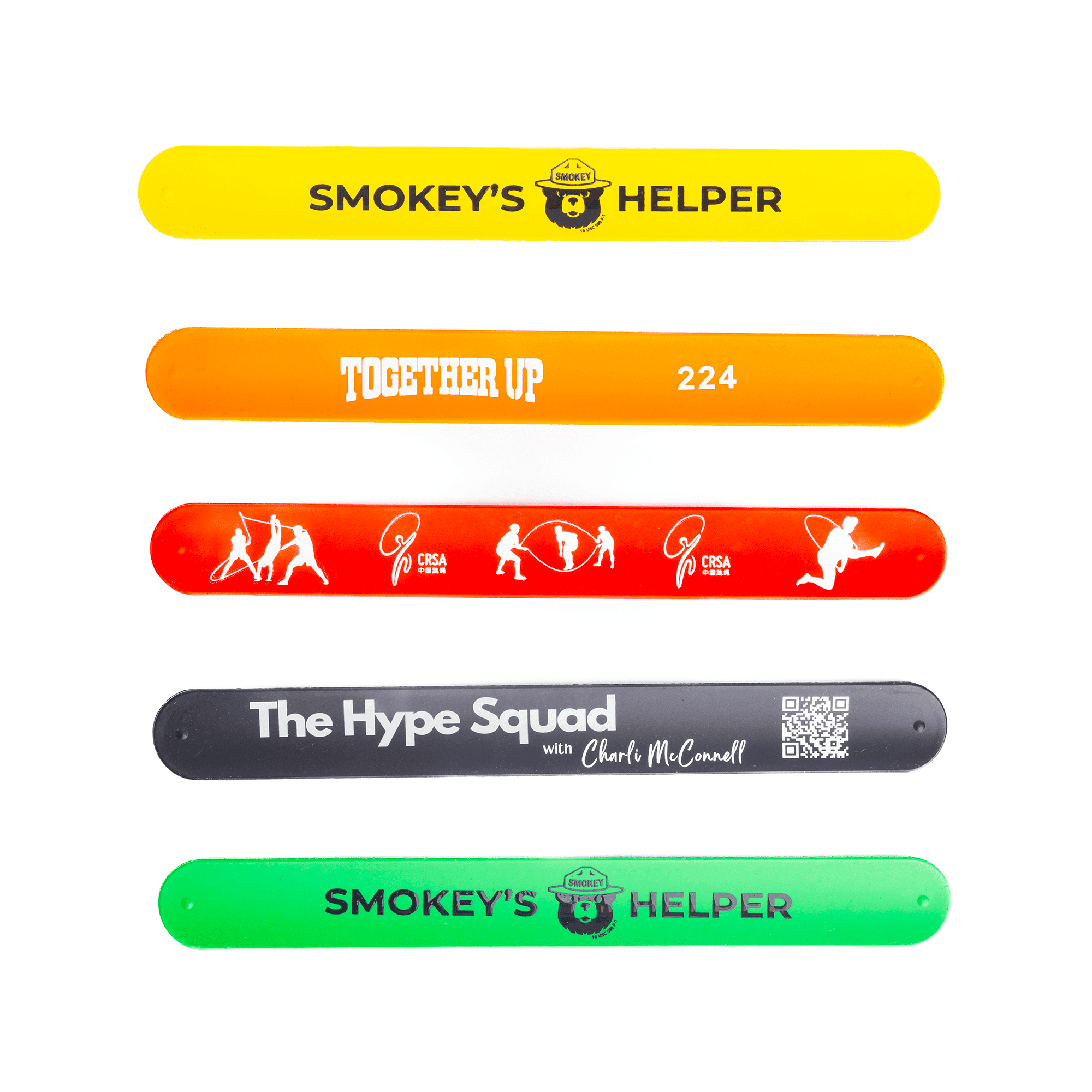Five silicone slap-bands in yellow, orange, red, and green featuring various designs and a logo on each. Silicone Slap-Band - Image 1