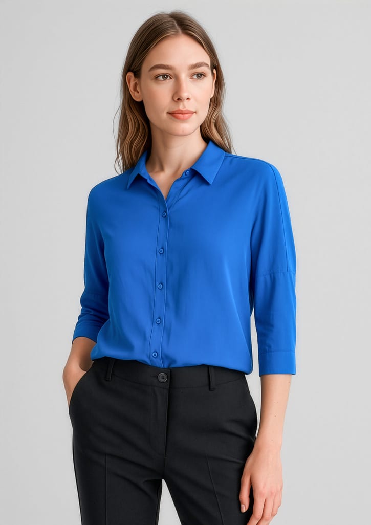 A vibrant blue 3/4 sleeve blouse with a collar and buttons, paired with black trousers. Womens Dahlia 3/4 Sleeve Blouse - Image 1