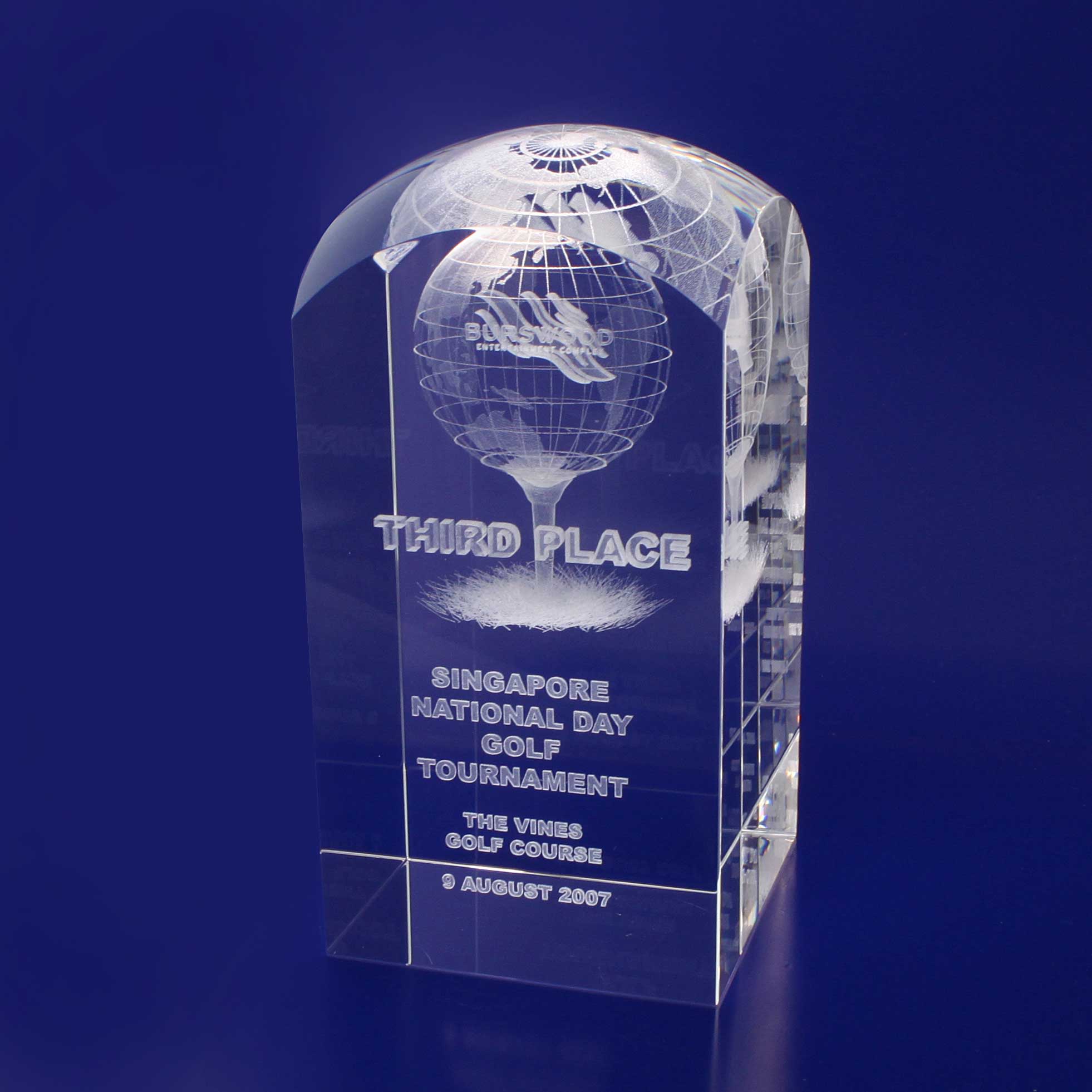 A crystal trophy with a dome top, featuring engraved text and a globe design, set against a blue background. 3D Crystal Dome Top Tower (120mm) - Image 1