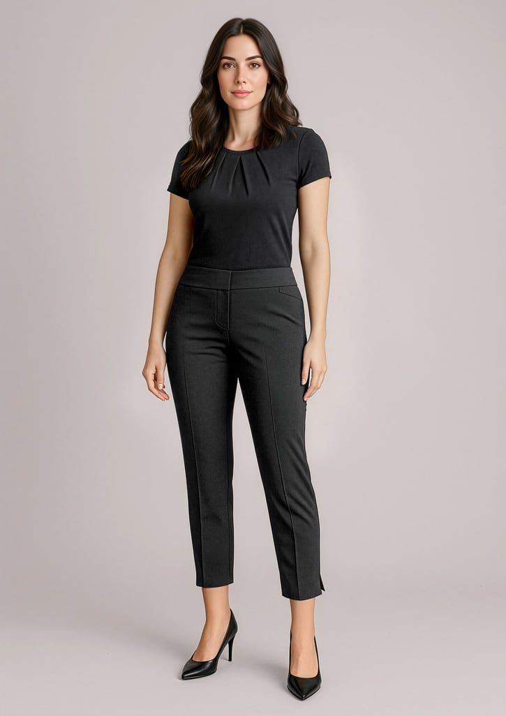 A woman in black slim leg pants paired with a black top, standing in a neutral background. The pants have a mid-waist design. Womens Siena 7/8 Mid-waist Slim Leg Pant - Image 1