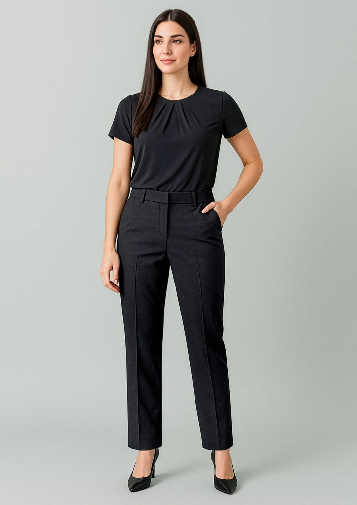 A woman in a black top and tapered black slacks with an adjustable waist, standing against a neutral background. Womens Renew Tapered Adjustable Waist Pant - Image 1