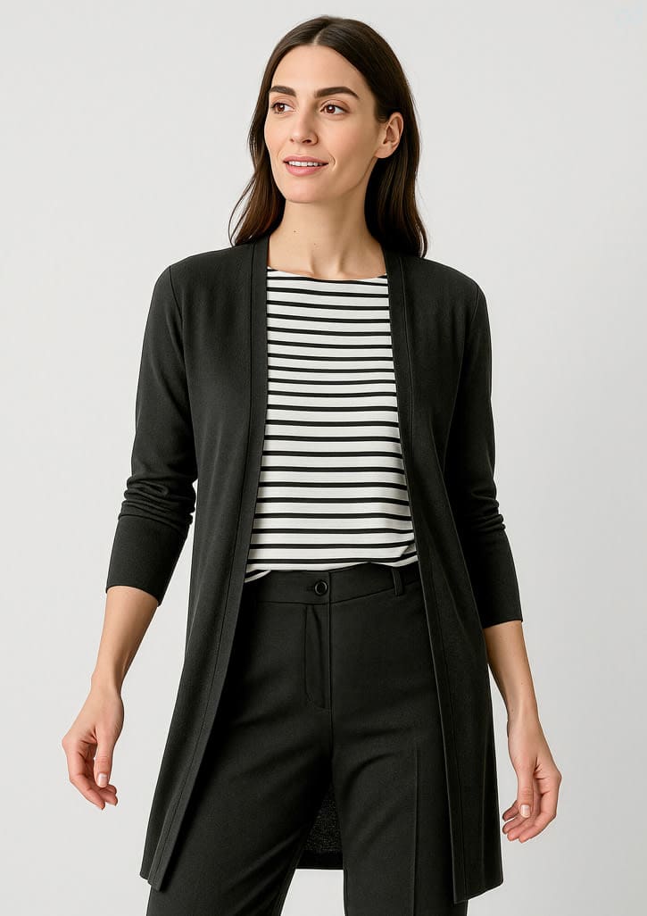 A longline cardigan in black, featuring a sleek design and open front. The model wears it over a striped top and black pants. Womens Chelsea Longline Cardigan - Image 1