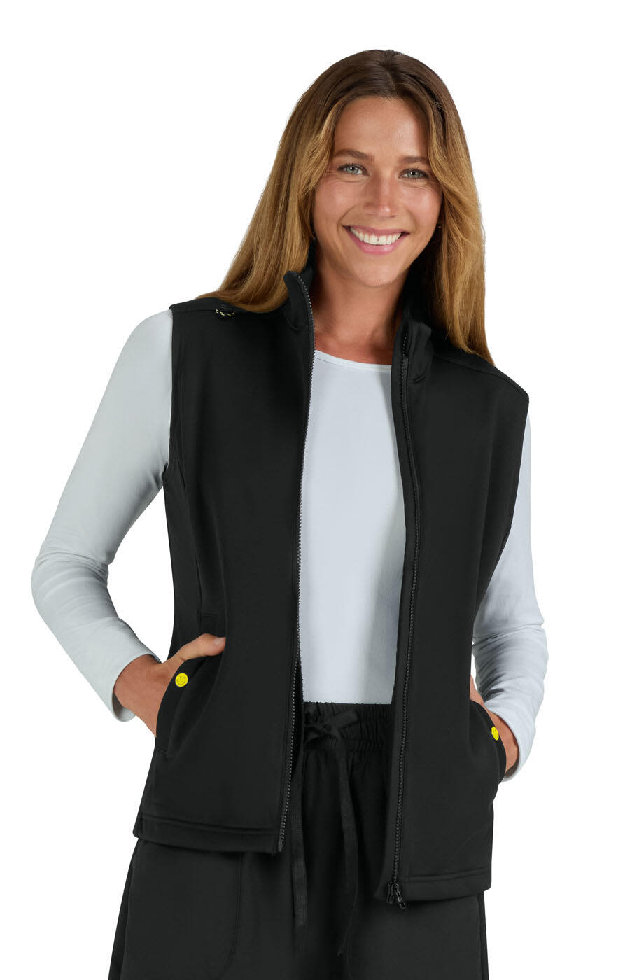 A black fleece vest with a zip front and pockets, worn by a smiling woman with long, wavy hair. Amused Fleece Vest - Image 1