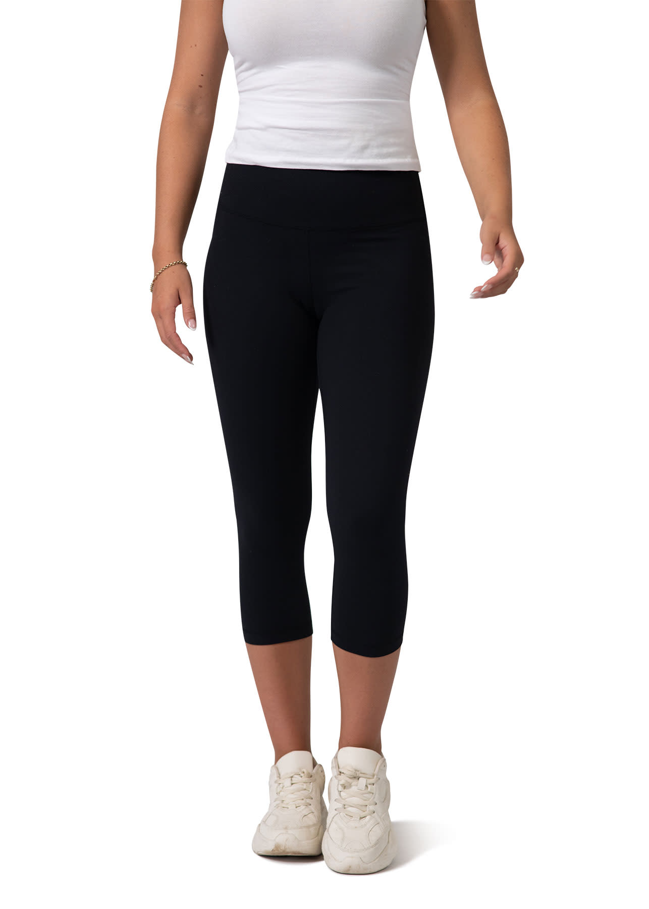 Black high-rise 3/4 leggings worn by a model with a white top and white sneakers. The leggings feature a simple design. Womens High-rise 3/4 Leggings - Image 1