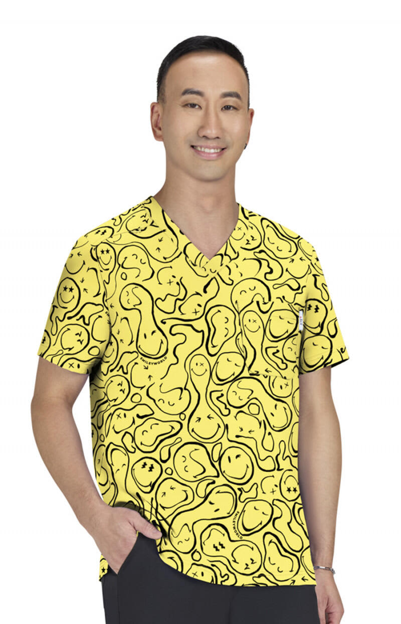 A bright yellow top featuring a playful print with various shapes and lines, worn by a man. It has a logo. Confident Top (Print) - Image 1