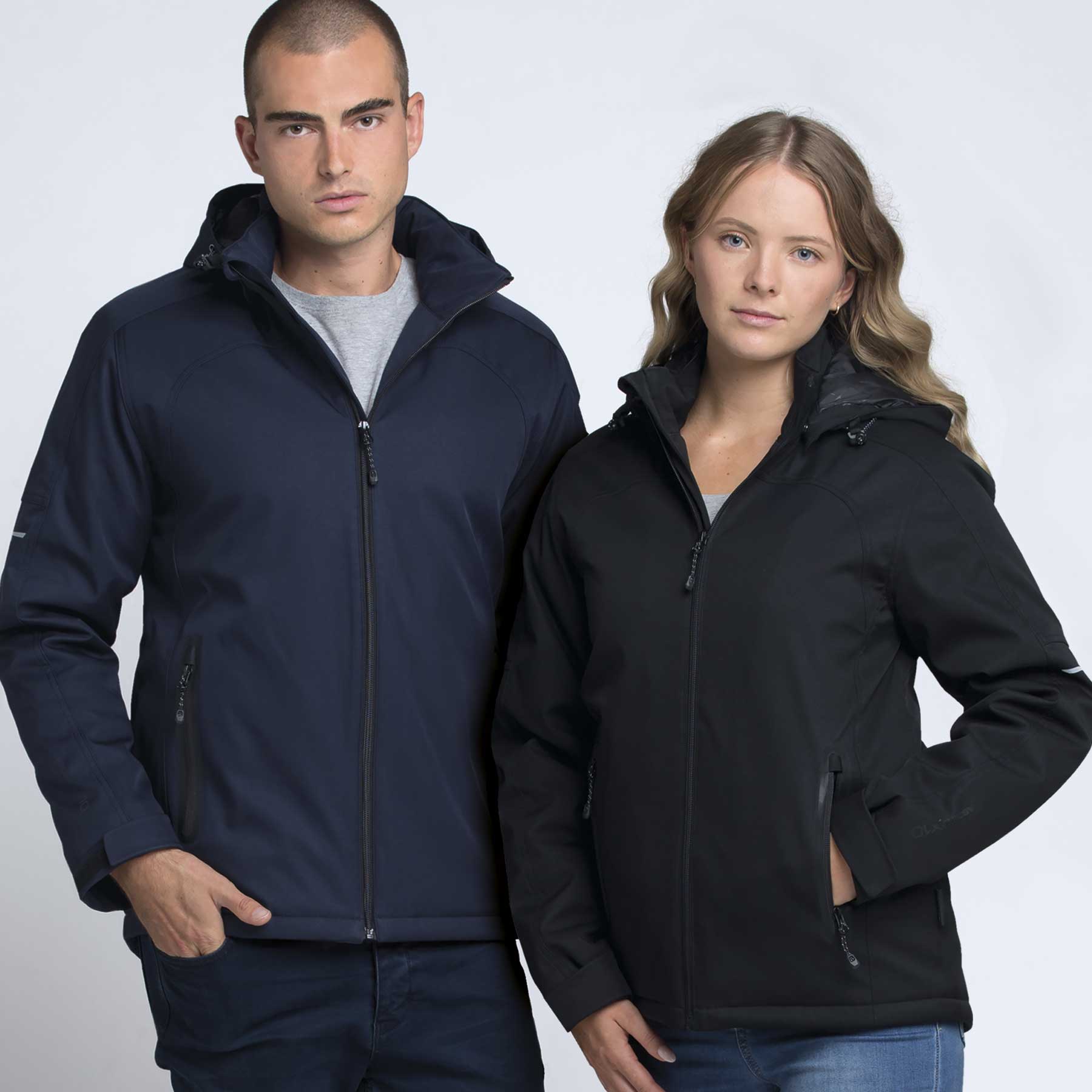 A navy soft shell jacket and a black soft shell jacket are worn by a male and a female model. Both jackets have hoods and zippers. Ascend X10 Jacket - Image 1