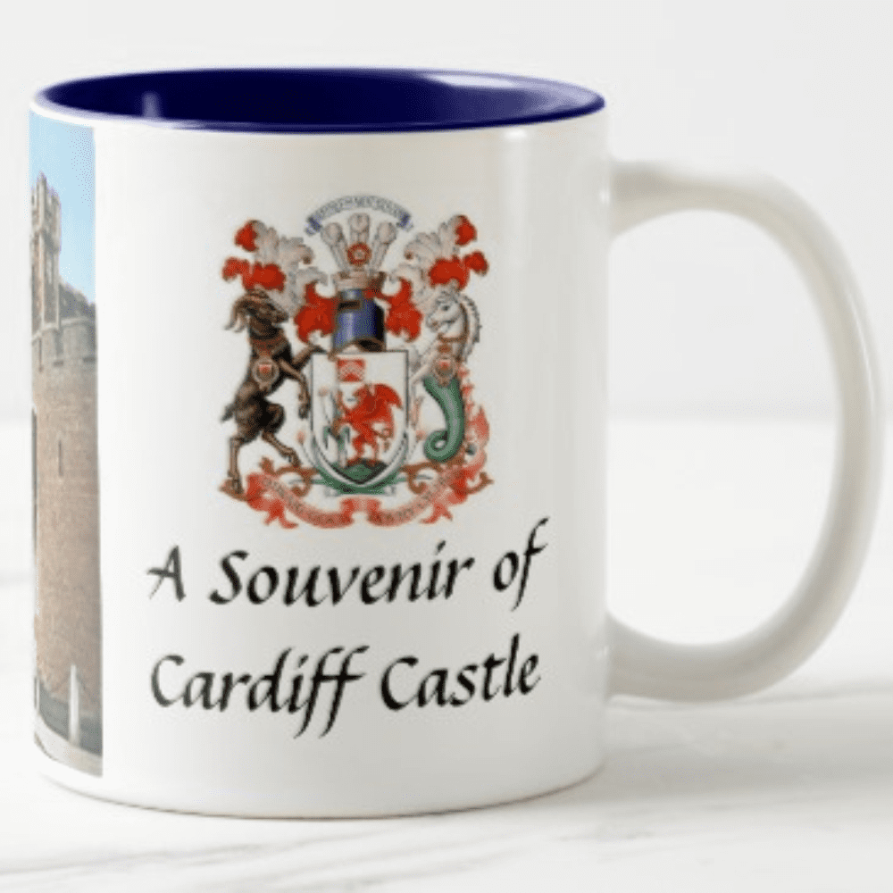 A mug featuring a photograph of Cardiff Castle and a decorative coat of arms, with a blue interior. Xavier dyesub ceramic mug - Image 1