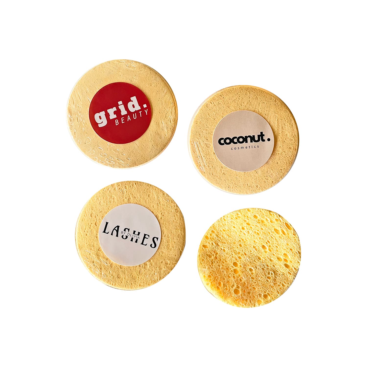 Compressed sponges in a pack of 10, featuring various round yellow sponges with different branding. Compressed Sponges (10 pack) - Image 1