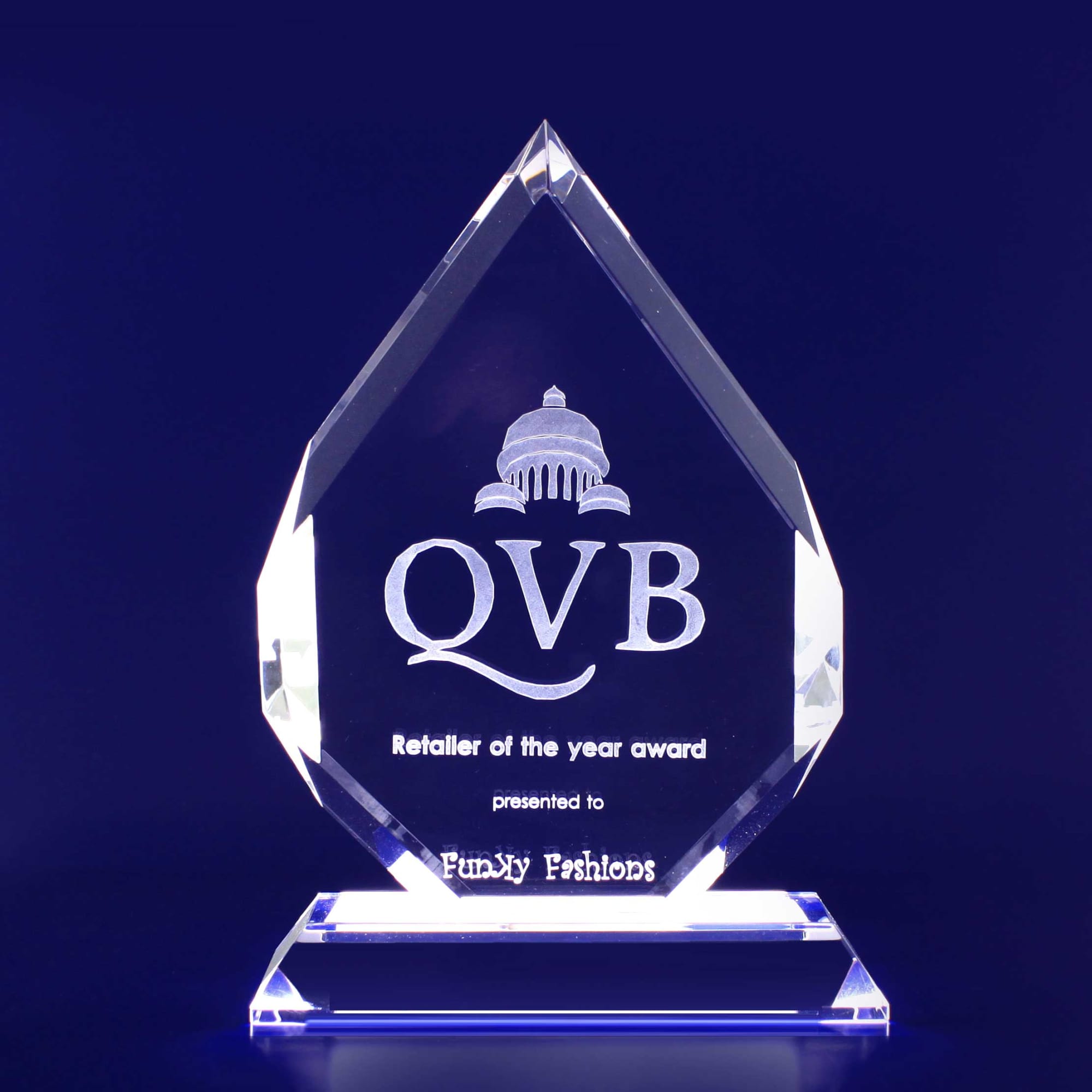 A clear crystal trophy in a tear-drop shape with a pedestal base. Features a logo and engraved text. 3D Crystal Spear Trophy (155mm) - Image 1