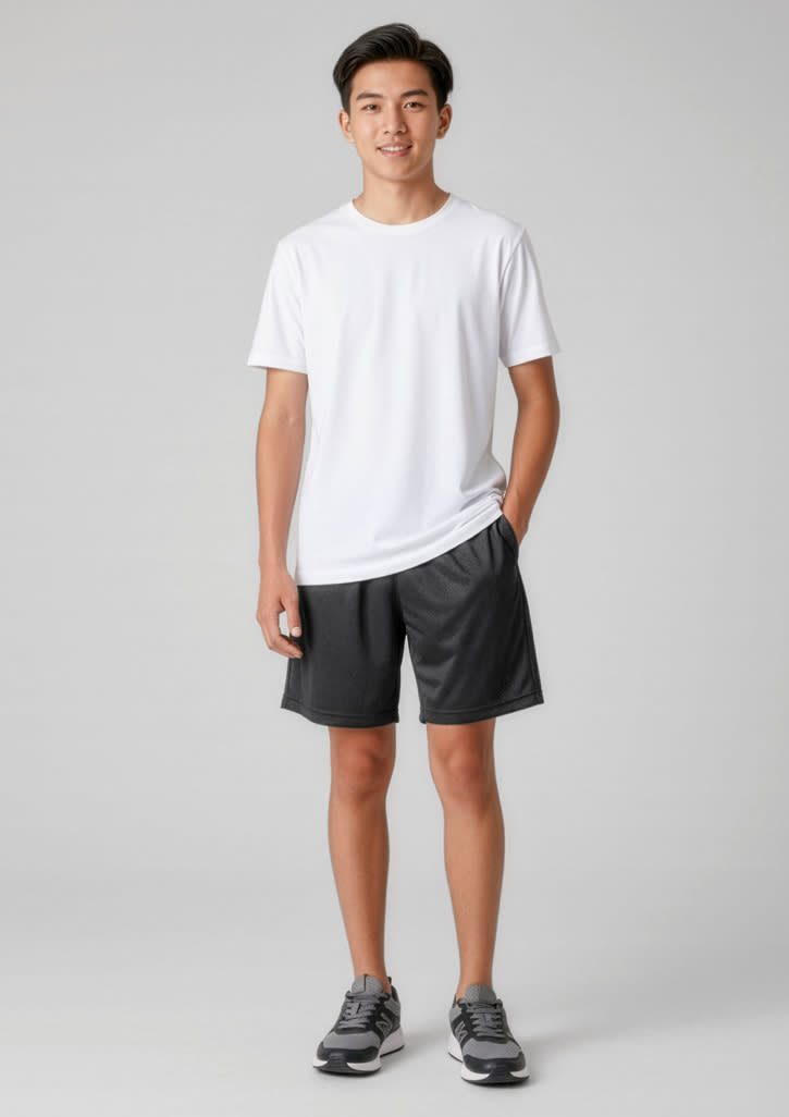 A model wearing black sports shorts and a white t-shirt, standing with hands in pockets. The shorts feature a logo. Kids BIZ COOL™ Short - Image 1