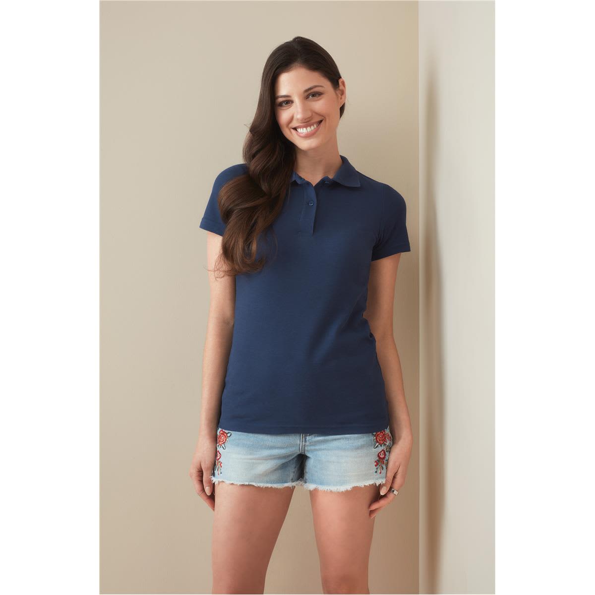 A women's heavyweight polo shirt in navy blue, featuring a classic collar and short sleeves. It has a logo detail. Women's Heavyweight Polo - Image 1