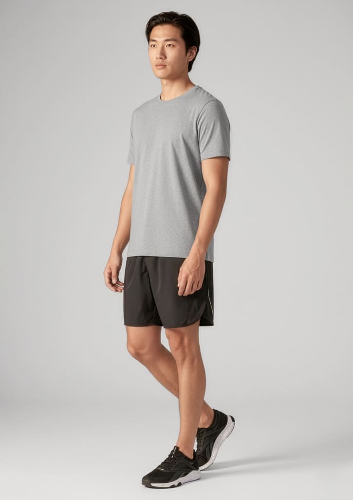 A man wearing a grey t-shirt and black sports shorts, paired with black athletic shoes. The outfit features a logo. Mens Tactic Short - Image 1